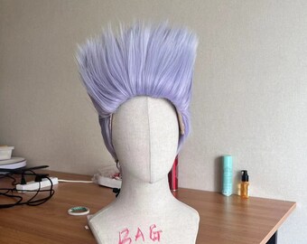 May include: A light purple wig with a high, spiky style is displayed on a mannequin head. The mannequin is on a wooden table. The text "BAG wigs" is written in red marker on the mannequin.