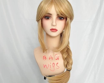 May include: A blonde wig with bangs and a braid. The wig is on a mannequin head and the text "BAG WIGS" is written on the mannequin's chest.