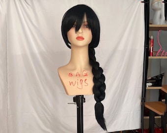 May include: A black wig with a long braid on a mannequin head. The wig is styled with a side parting and bangs. The mannequin head is on a black stand. The text "BAG WIGS" is written on the mannequin's neck.