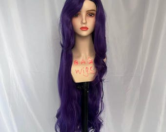 May include: A long, wavy, deep purple wig styled on a mannequin head. The wig features a side part and long, flowing locks. The mannequin has a neutral expression and is set against a white backdrop. The text "BAG wigs" is written on the mannequin.