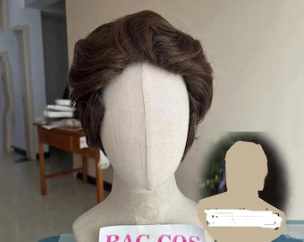 May include: A brown wig with short, wavy layers, presented on a mannequin head. The mannequin is on a patterned surface, with a sign that reads "BAG COS".