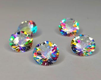 May include: Five round, faceted, iridescent gemstones with rainbow colors. The gemstones are clear and have a high shine.