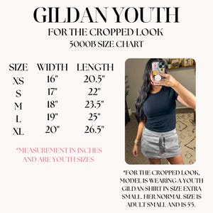 May include: A size chart for Gildan Youth cropped shirts, with measurements in inches. The chart includes sizes XS to XL, with width ranging from 16" to 20" and length from 20.5" to 26.5". The image also shows a person wearing a black shirt.