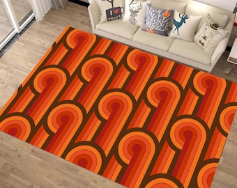 May include: A brown and orange area rug with a geometric pattern of curved lines and circles. The rug has a retro 70s style.