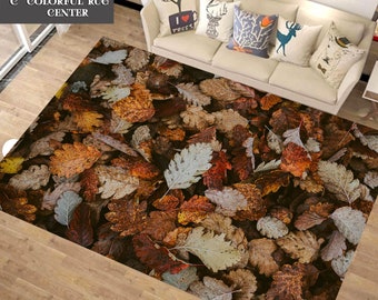 May include: A brown, beige, and white area rug with a pattern of autumn leaves. The rug is made of a soft, plush material and is perfect for adding a touch of warmth and style to any room.