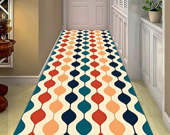 May include: A rectangular hallway runner rug with a repeating pattern of connected teardrop shapes in red, orange, teal, and navy blue on an off-white background. The rug is placed in a hallway with a white door and trim.