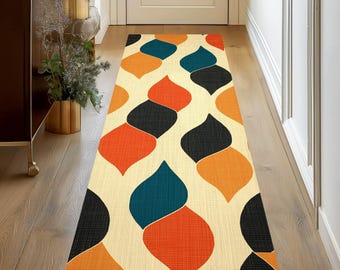 May include: A beige runner rug with a geometric pattern of orange, teal, and black teardrop shapes. The rug has a woven texture.