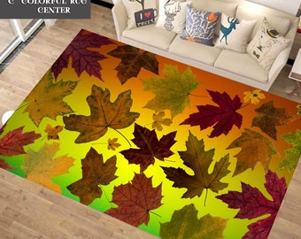 May include: A rectangular rug featuring a vibrant autumn leaf design. The rug showcases large, detailed maple leaves in shades of brown, red, and green against a gradient background of yellow and orange. The text "COLORFUL RUG CENTER" is in the top left corner.