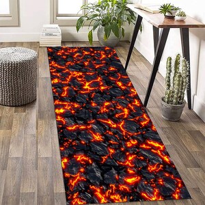 May include: A black and orange area rug with a lava rock pattern. The rug is rectangular and has a textured surface.