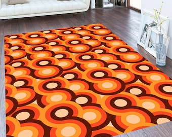 May include: A retro-style area rug with a repeating pattern of orange, brown, and cream concentric circles.