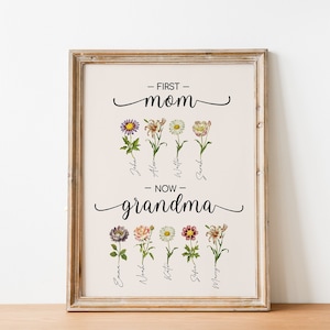 May include: A framed print with the text "First Mom" and "Now Grandma" with floral illustrations and names of children below each flower.