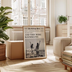 May include: A framed print of a newspaper article with the headline "Breaking News: And They Were Roommates". The article features a photo of two women on a beach. The text "Your Photo Here" is printed on the photo.