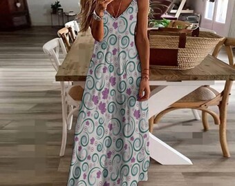 May include: A sleeveless, V-neck dress with a white background and a repeating pattern of teal swirls and purple leaf shapes. The dress has a flowing, floor-length design.