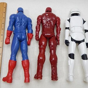 May include: Three action figures, Captain America in blue and red, Iron Man in red, and a Stormtrooper in white.