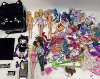May include: A collection of dolls and accessories, including a black cat-shaped purse, a black and white doll with purple hair, a doll with pink hair and a pink dress, and a doll with brown hair and a blue shirt. There are also many colorful clothes and accessories for dolls.