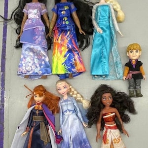 Puede incluir: Una colecci&oacute;n de siete mu&ntilde;ecas de princesas Disney, incluyendo Elsa, Anna, Moana y dos versiones de Pocahontas. Las mu&ntilde;ecas llevan todas sus atuendos caracter&iacute;sticos y tienen el pelo largo y suelto.