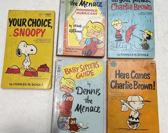 May include: A collection of five vintage comic book covers featuring the characters Charlie Brown and Snoopy. The covers are in various colors, including yellow, red, blue, and green. The titles of the books are "Your Choice, Snoopy", "Dennis the Menace: Household Hurricane", "It's Raining on Your Parade, Charlie Brown", "Baby Sitter's Guide by Dennis the Menace", and "Here Comes Charlie Brown!"