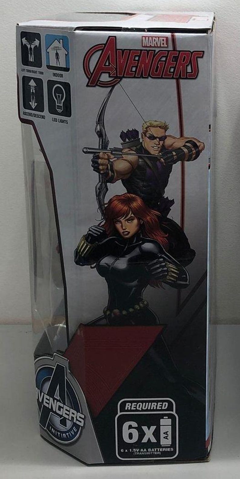 May include: A box for a Marvel Avengers toy featuring Black Widow and Hawkeye. The box is red, white and black with a picture of the characters on the front. The text "MARVEL AVENGERS" is printed in white on a red background. The box also includes instructions for use and a list of required batteries.