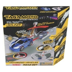 May include: A Tagamoto Code the Road motorized vehicle road set with a blue car, a toll booth, and a road track. The car has working headlights and taillights, and the toll booth has a working gate. The set is designed for children ages 4 and up.
