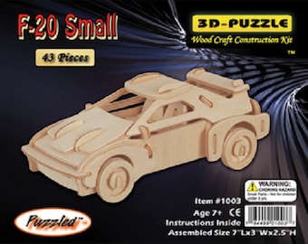 May include: A wooden 3D puzzle of a small, light brown race car. The puzzle is called "F-20 Small" and has 43 pieces. The assembled size is 7 inches long by 3 inches wide by 2.5 inches high.