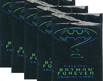 May include: Five packs of Batman Forever trading cards. The packs are black with a green and blue Batman logo and text. The text reads "FLEER 1995 BATMAN FOREVER TRADING CARDS 6 CARDS."