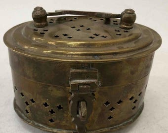 May include: A brass box with a hinged lid and a latch. The box has a decorative pattern of small holes and is oval in shape.