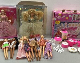 May include: A collection of Barbie dolls and accessories, including a pink and white tea set, a pink and white dollhouse, and several Barbie dolls in different outfits. The dolls are all wearing pink and white dresses and have long blonde hair.