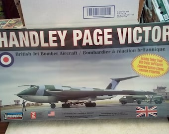 May include: A model kit of a Handley Page Victor British jet bomber aircraft. The box art features a green and white model of the aircraft on a runway with a tanker truck and figures. The box includes the text "Handley Page Victor" and "British Jet Bomber Aircraft".