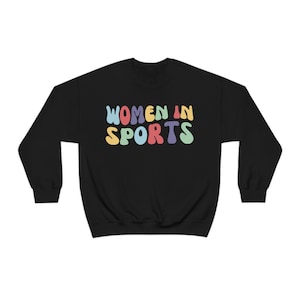 May include: Black sweatshirt with the text "WOMEN IN SPORTS" in rainbow coloured letters.
