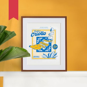 May include: A framed print with a yellow and blue illustration of a banana and the text "Sabor Criollo" in a blue and white patterned border. The text "Flour Bistro" and "5¢" are also included in the design.