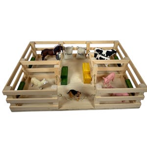 May include: A wooden farm playset with a variety of animal figurines, including a horse, cow, sheep, and pigs. The playset has a fence and stalls for the animals, as well as bags of feed labeled "Corn" and "Oats".
