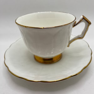 Aynsley Teacup & Saucer molded white bone china in “Golden Crocus” pattern, gold rims and foot.  Vintage 1980&#39;s England