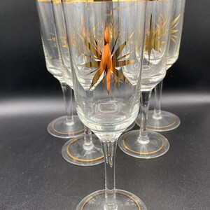 Champagneflöjter x6. Klart glas, guldfärgade atomstjärnor, kanter och fotdetaljer. Vintage MCM 60-tal.