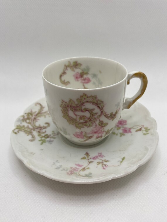 Theodore Haviland demi-tasse cup and saucer.  White porcelain with pink roses. Antique 1903 Limoges, France. *Has cracks.
