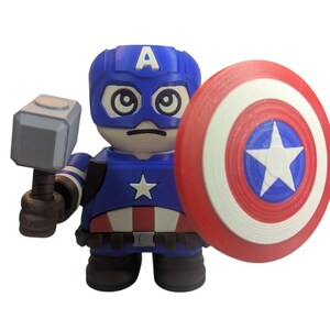 May include: A blue, red, and white Captain America figurine holding a gray hammer and a shield. The figurine has a blue helmet with a white "A" and a star on the chest. The shield is red, white, and blue with a white star.