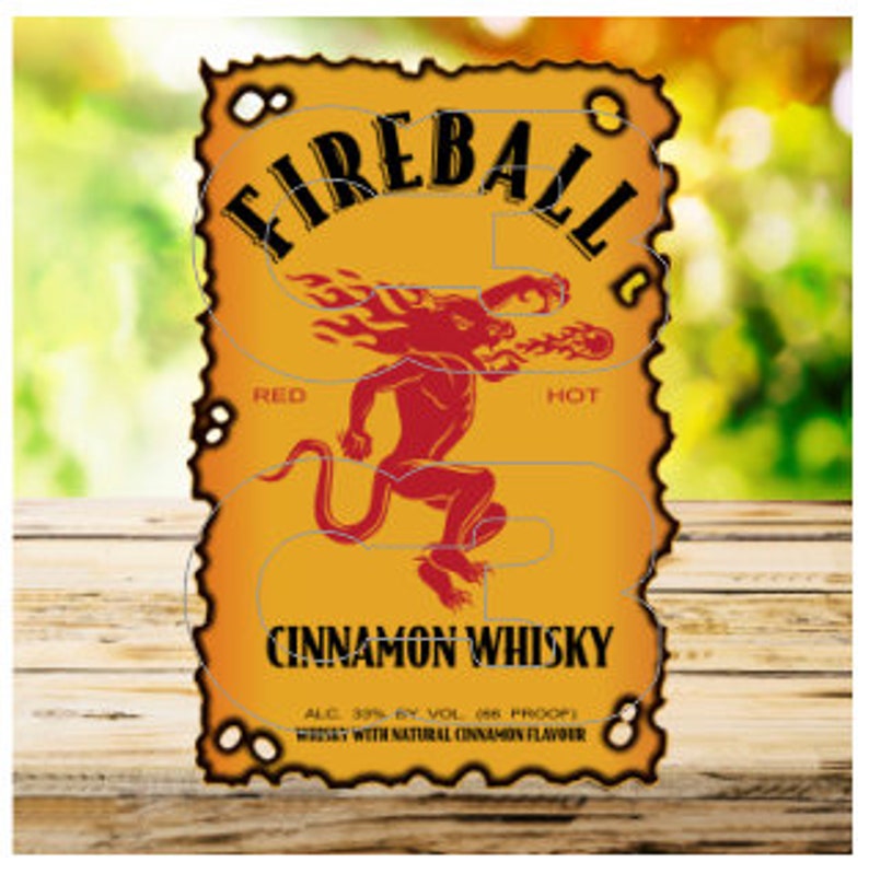 May include: A red and yellow label with the words "FIREBALL" and "CINNAMON WHISKY". The label also includes the text "RED" and "HOT" and a red cartoon dragon with flames. The label reads "ALC 30% BY VOL 86 PROOF" and "WHISKY WITH NATURAL CINNAMON FLAVOR".