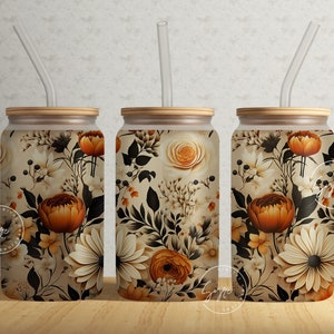May include: Three stainless steel tumblers with a floral pattern in shades of brown, orange, and white. The tumblers have a wooden lid and a clear plastic straw.