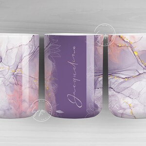 May include: White ceramic mug with a wraparound design featuring a watercolour effect in shades of purple, pink, and gold. The centre panel has the name "Jacqueline" in script on a purple background. Floral accents are also present.