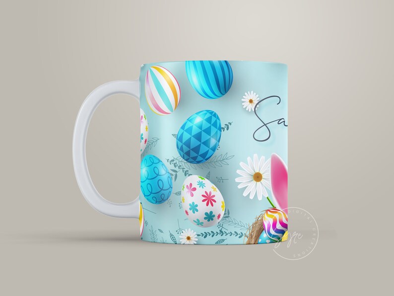 May include: A white ceramic mug with a blue background and a pattern of colorful Easter eggs and flowers. The text "Sa" is visible on the mug.