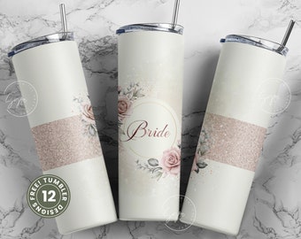 May include: Three stainless steel tumblers with a white background and a pink glitter band. The center tumbler has a floral design with the word "Bride" in a gold circle.