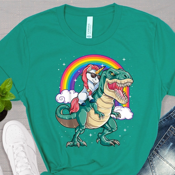 Unicorn Riding T rex Dinosaur Boys Girls Men Women Rainbow T-Shirt | Cute Popular Unisex Graphic Tee | Trendy Summer Short Sleeve Shirt