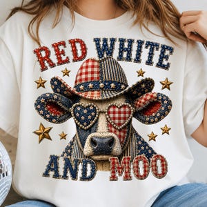 May include: A white t-shirt featuring a graphic of a cow wearing a cowboy hat and heart-shaped sunglasses. The design incorporates red, white, and blue patterns with stars and plaid. The text RED WHITE AND MOO is printed in a stitched font.