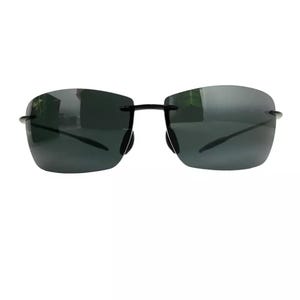 May include: Black rimless sunglasses with dark gray lenses.
