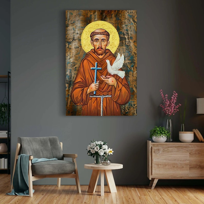 May include: A painting of Saint Francis of Assisi, a Catholic saint, holding a cross and a dove. The painting is done in a traditional style with a gold background and a halo around the saint's head.