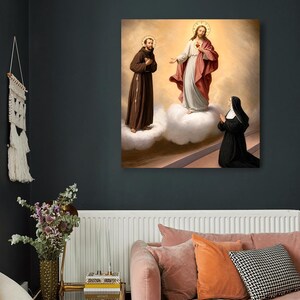 May include: A square wall art print depicting a religious scene with a figure in a brown habit standing on a cloud, a central figure in a white and red robe standing on a cloud, and a kneeling figure in a black habit with a white head covering.