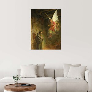 May include: A framed print of a religious painting depicting a monk looking up at an angel. The angel is descending from above, wearing a red and gold robe. The artwork is set in a stone structure with a small window.