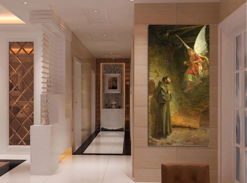 May include: A vertical canvas print of a religious scene. An angel with large white wings descends towards a man in a brown robe. The background is a stone structure with warm lighting.
