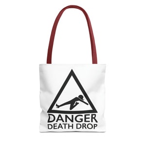 May include: White tote bag with maroon handles. The bag features a black warning sign with a stick figure falling and the text "DANGER DEATH DROP".