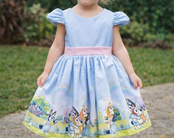 Luxury Bluey Bingo dress with blue background.