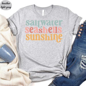 a t - shirt that says saltwater seashells sunshine